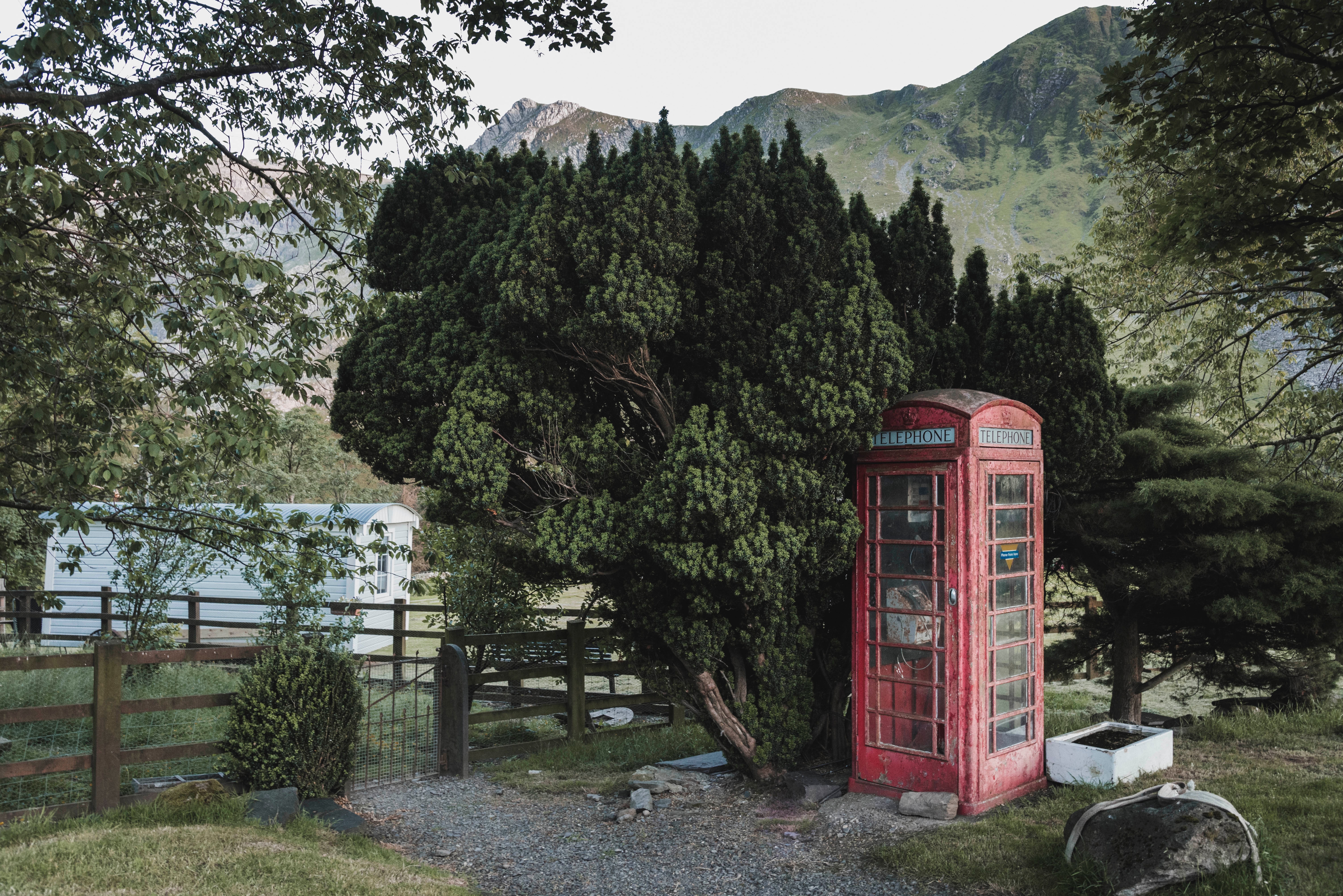 A red phone booth in the country